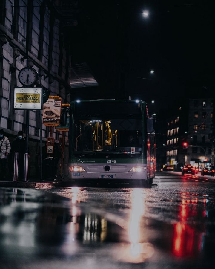 A bus on a city street at night