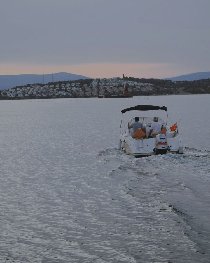 A motorboat under way at dusk