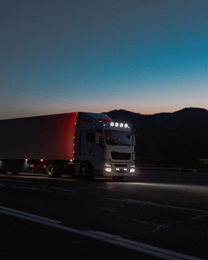 A truck on the road at dusk
